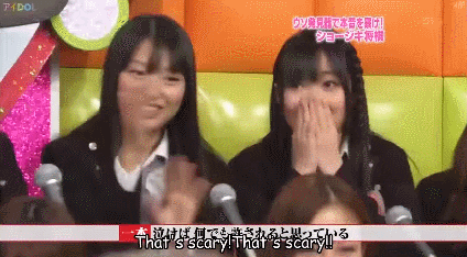 The hand wave gesture in Japan is like saying no, or that's not true. This girl did it so fast, though.